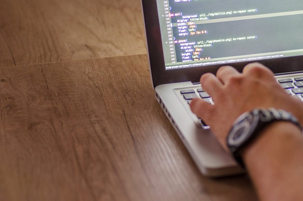 pexels photo 574069 Close-up of a person coding on a laptop, showcasing web development and programming concepts.
